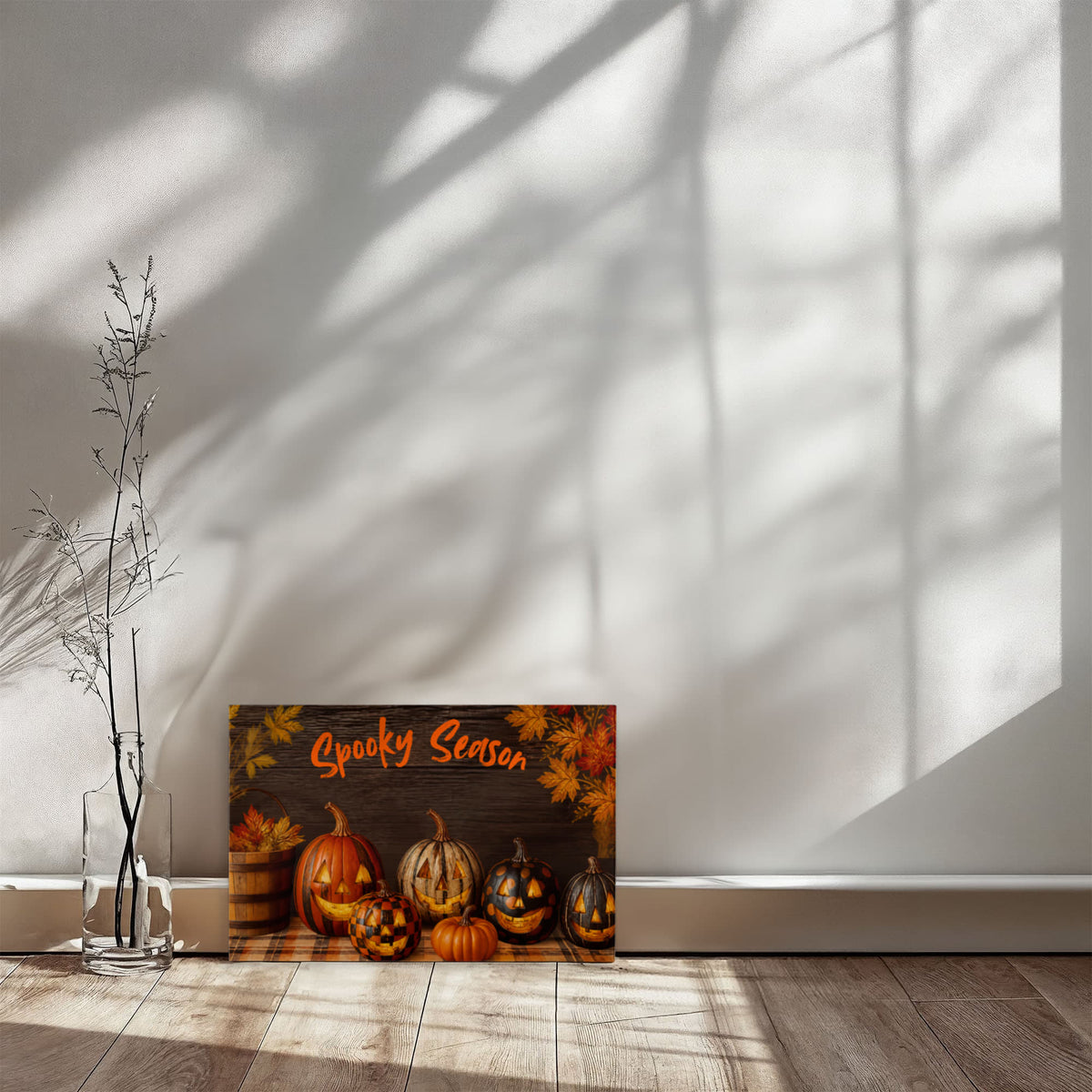 Halloween pumpkin canvas print on the floor with orange “Spooky Season” text