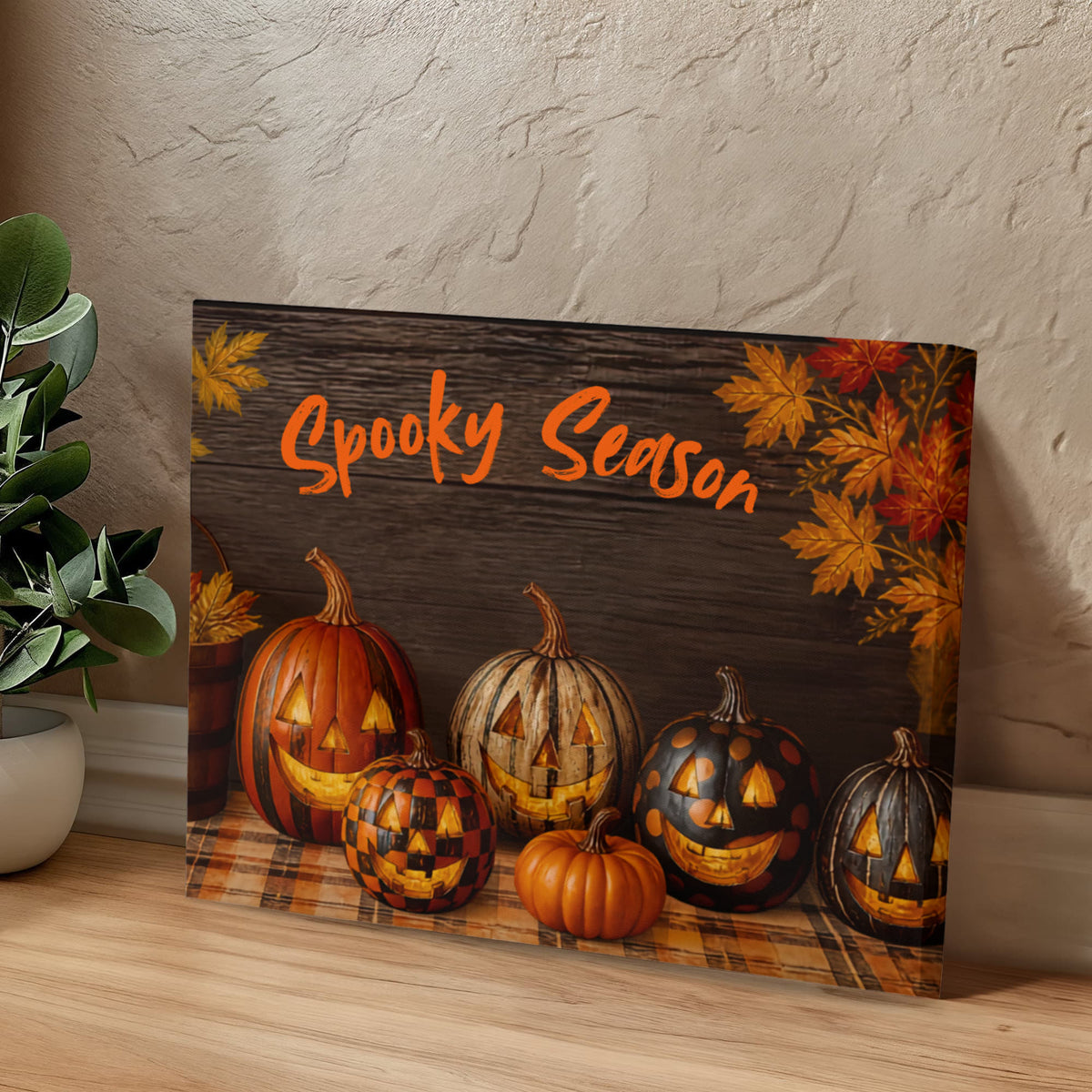 Halloween canvas print with jack-o'-lantern faces, orange pumpkins, and “Spooky Season” lettering.